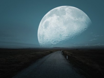 The moon is on the edge of the road