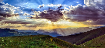 Puesta de sol sobre montañas verdes